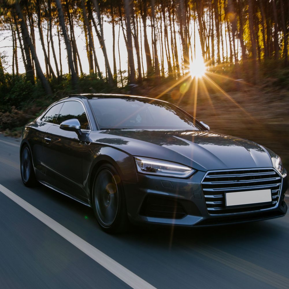 black-sport-car-highway-drive-sunset